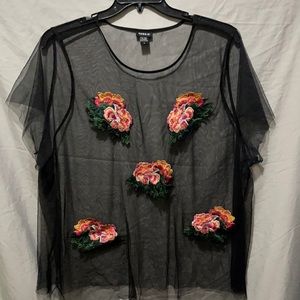Sheer black top with blunt cut hem and sleeves.  Rose embroidery on the front